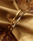 Gold and silver bangles on a beige fabric background