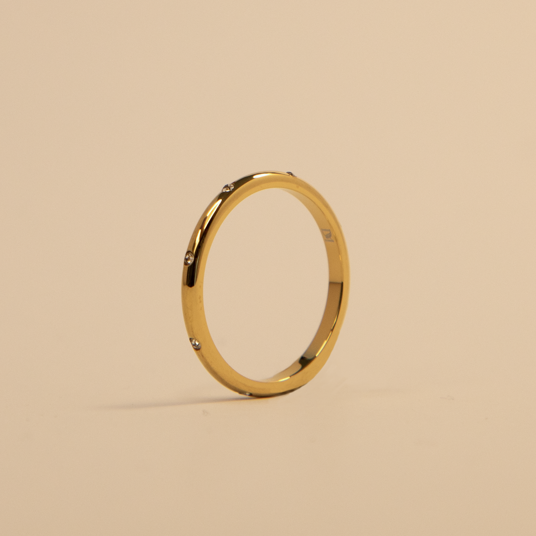 Gold bracelet on a beige background