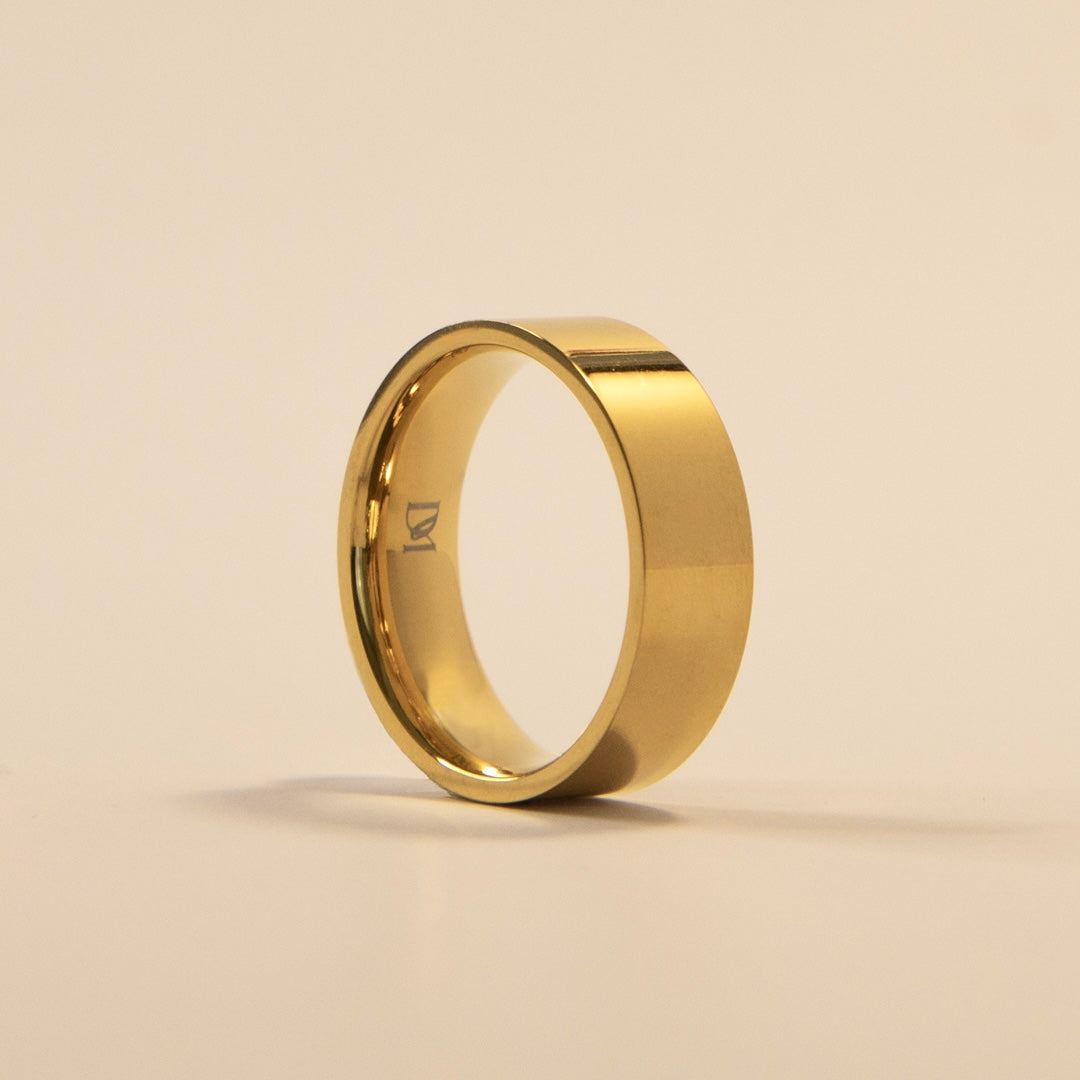 Gold ring on a beige background