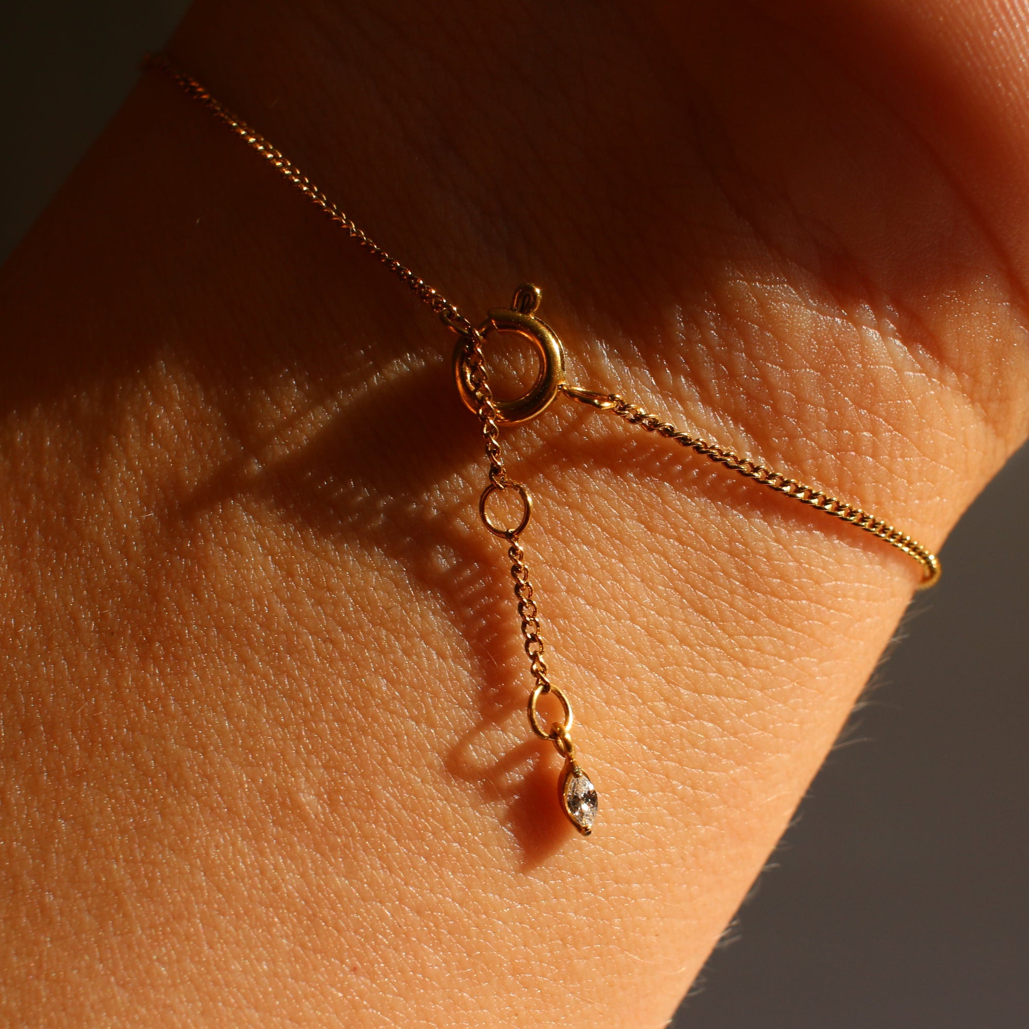 Gold bracelet on a wrist with a blurred background