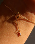 Gold bracelet on a wrist with a blurred background